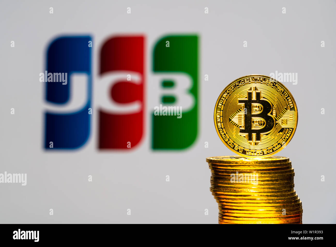 Gold Bitcoin coins with the JCB logo on background screen. A new type of  business finance concept Stock Photo - Alamy