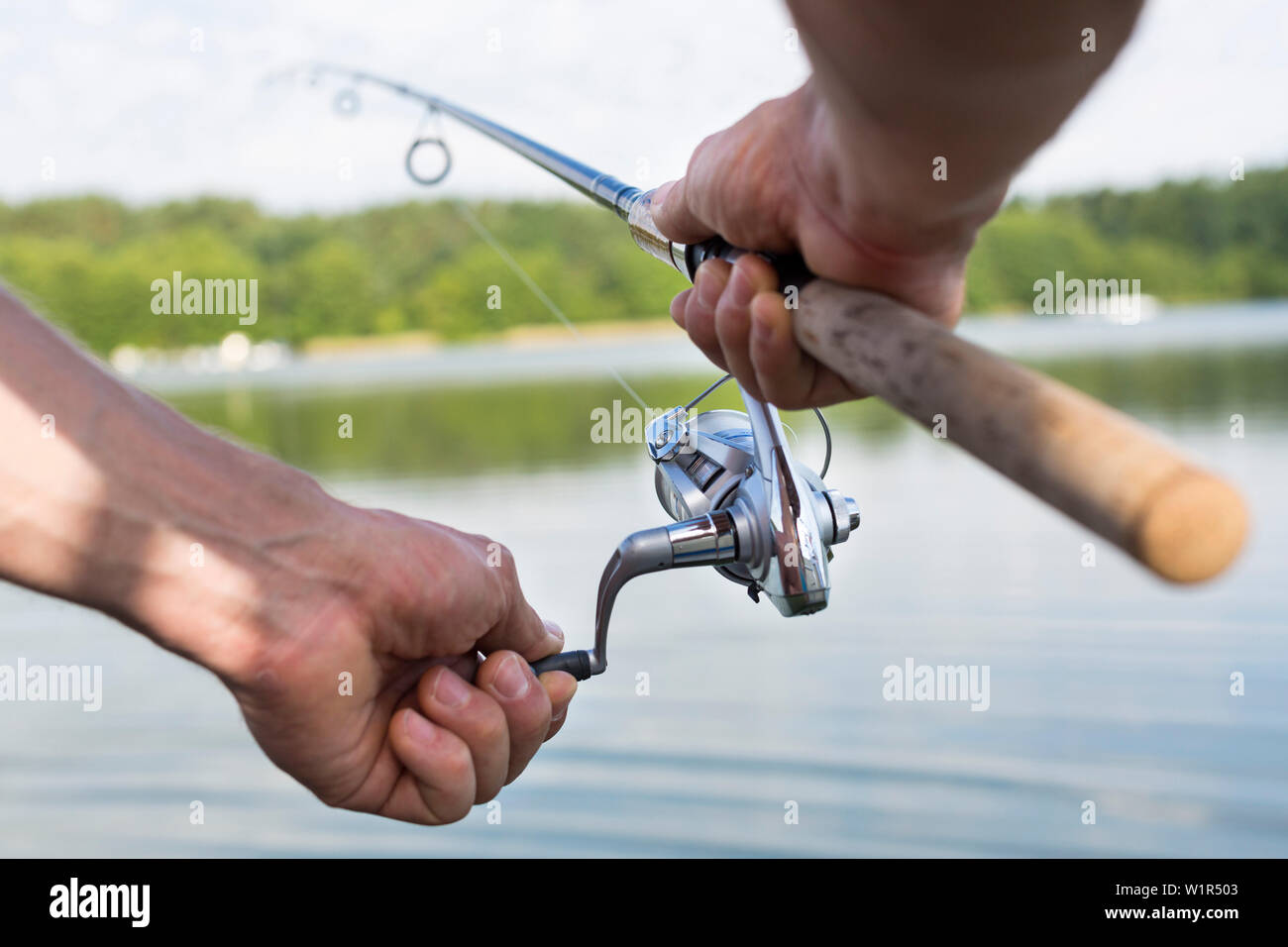 Fishing rod, hands, fishing from a boat, houseboat tour, Lake Mirower