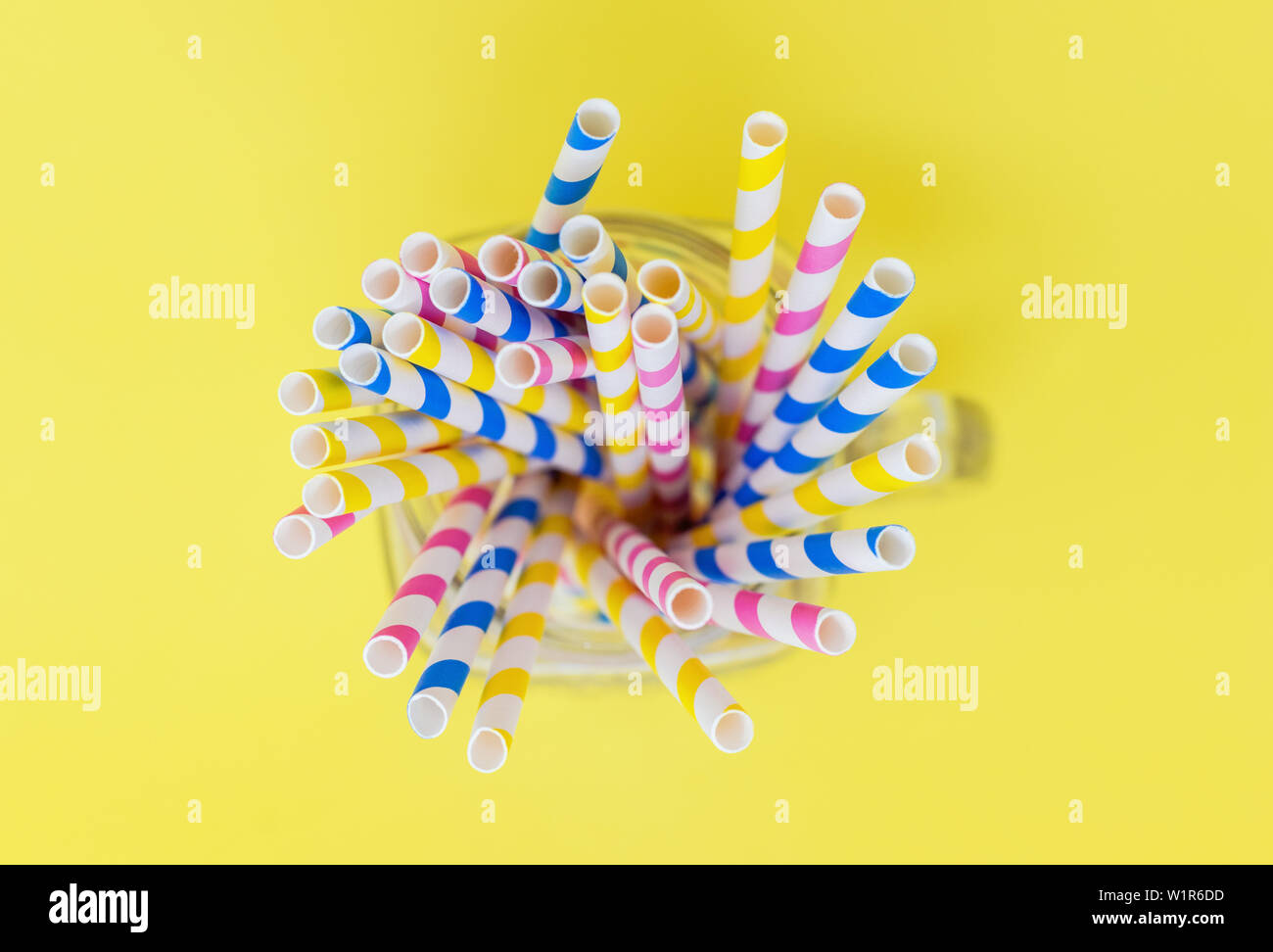 Paper straws from above on a yellow background, with a shallow depth of field, Stock Photo