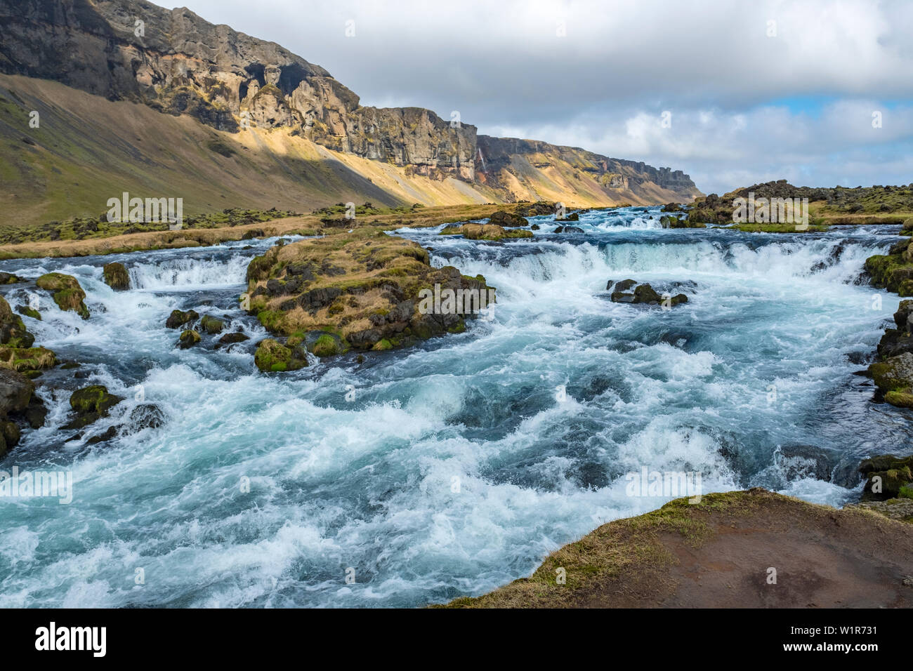 Raging river, waterfalls and rugged landscape on the southeastern coast of Iceland in the late springtime. Stock Photo