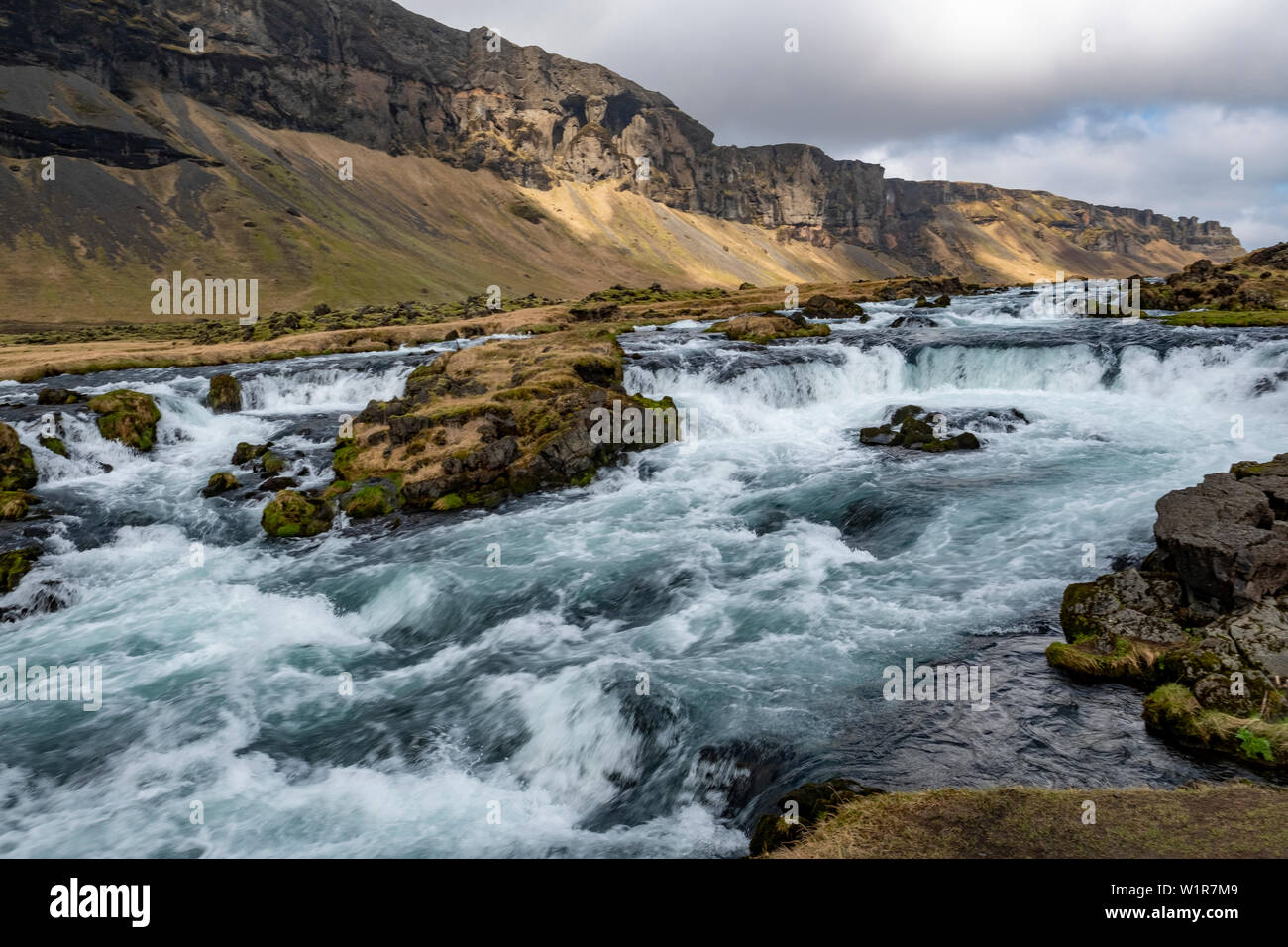 Raging river, waterfalls and rugged landscape on the southeastern coast of Iceland in the late springtime. Stock Photo