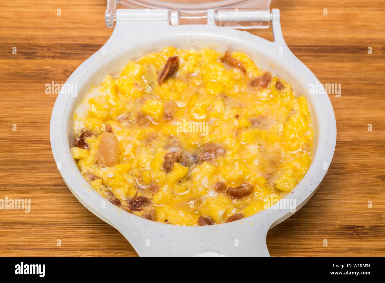 microwave scrambled eggs with ham bacon Stock Photo