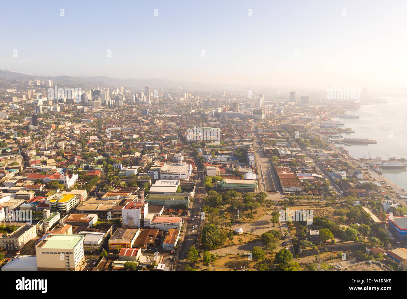 Cityscape in the morning. Streets and seaport of the city of Cebu, Philippines, top view. Panorama of the city with houses and business centers. Stock Photo