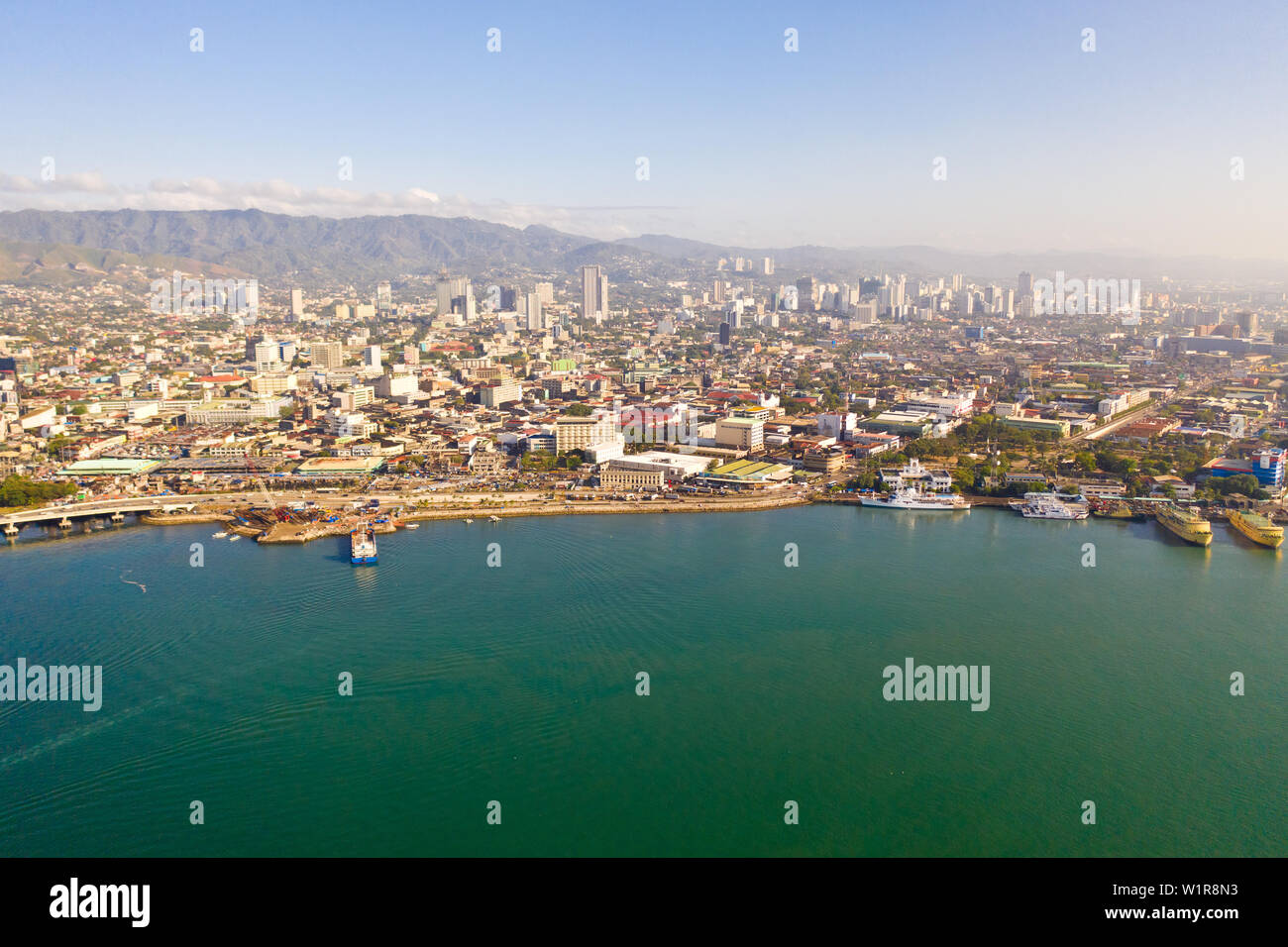 Cityscape in the morning. Streets and seaport of the city of Cebu, Philippines, top view. Panorama of the city with houses and business centers. Stock Photo