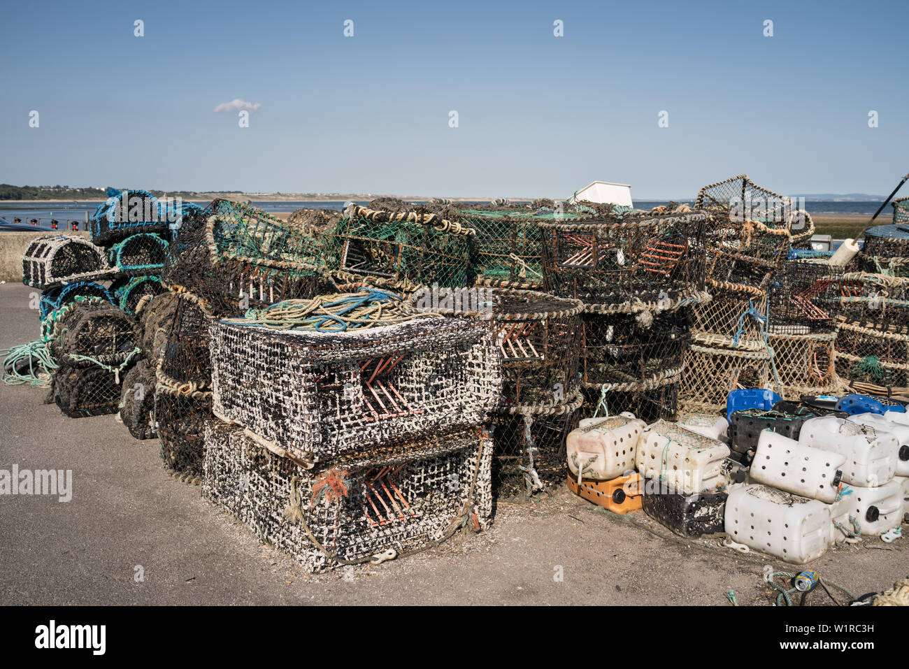 Lobster pots, crab pots and fishing gear on the quayside in Mudeford