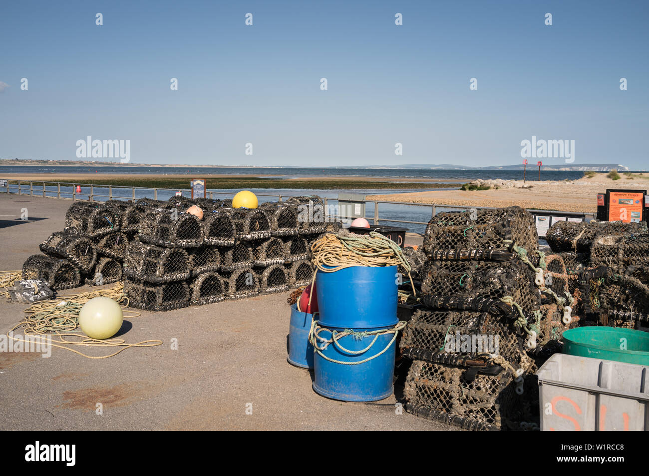 Lobster pots, crab pots and fishing gear on the quayside in Mudeford