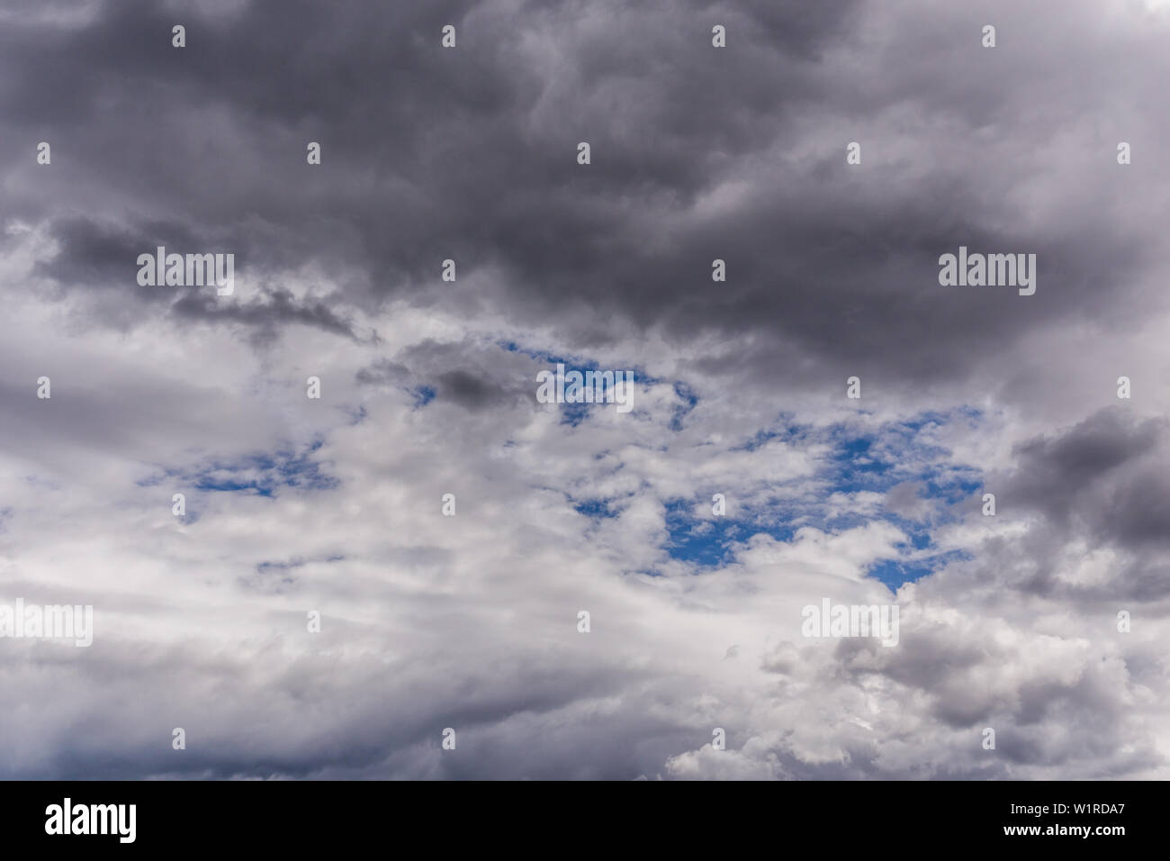 gray incoming near storm clouds daylight backdrop. Stock Photo