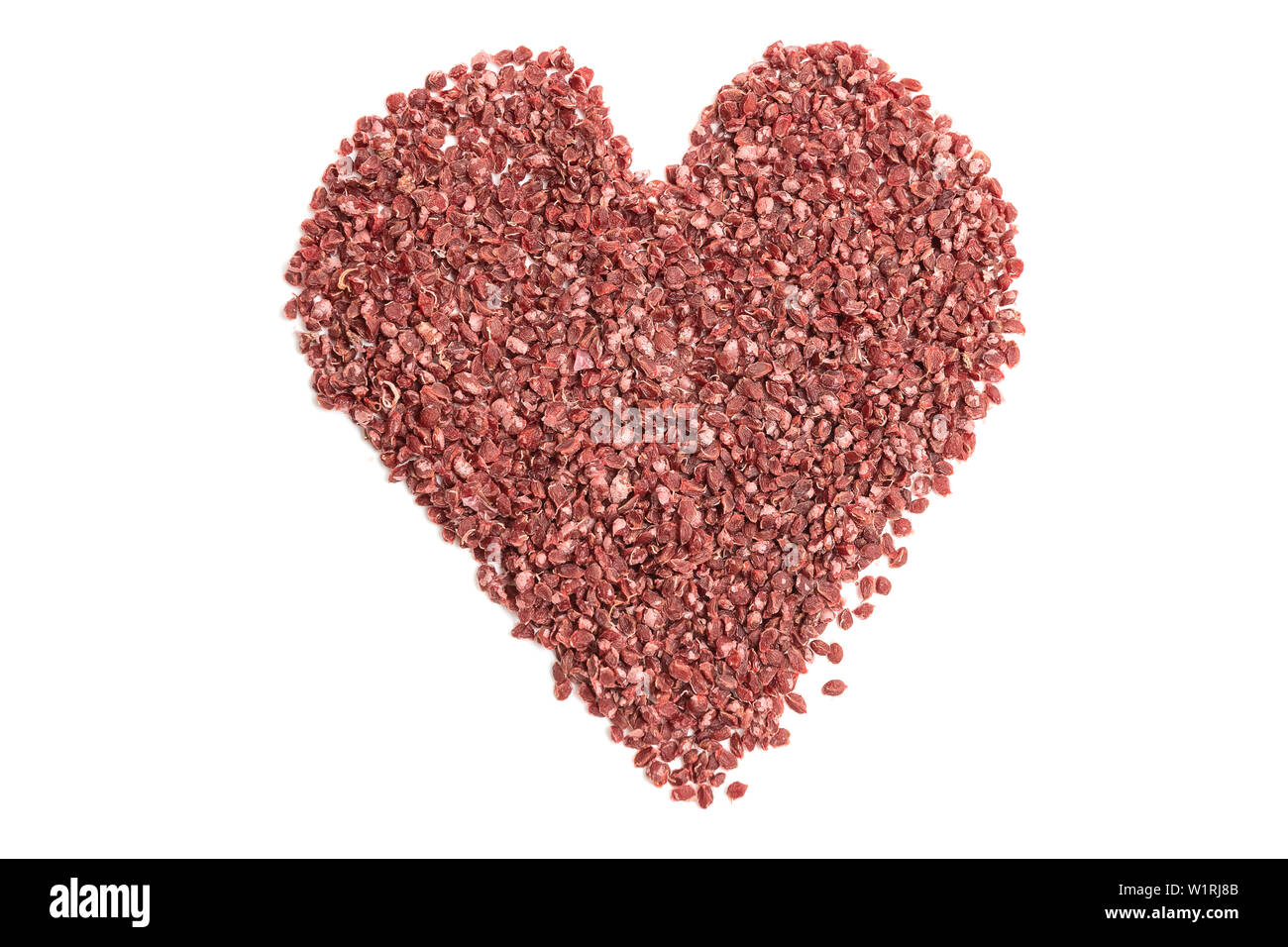Description: Currant seeds for sowing on a white background in the form of a heart Stock Photo