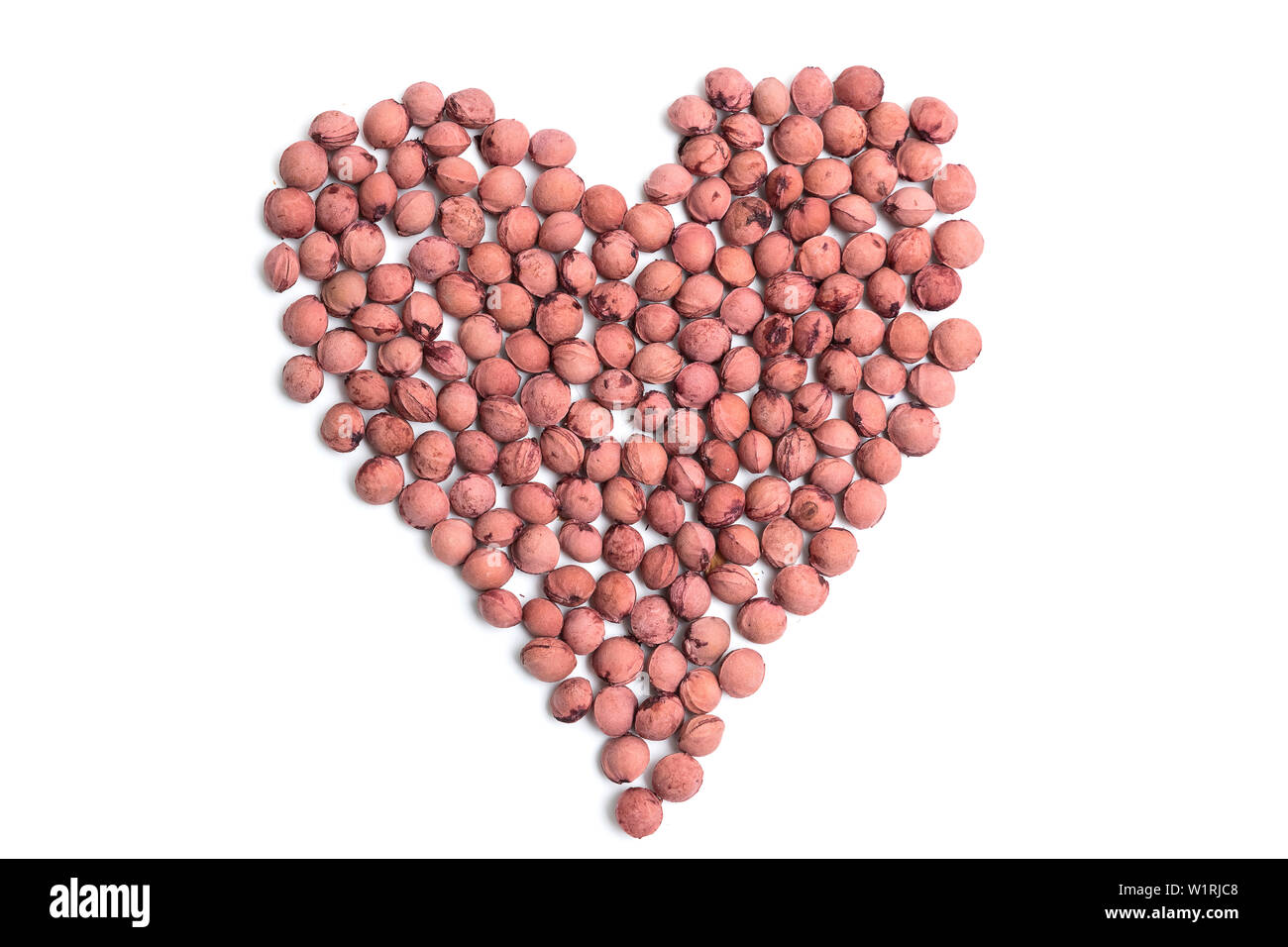 Description: Cherry stones on a white isolated background in the form of a heart Stock Photo