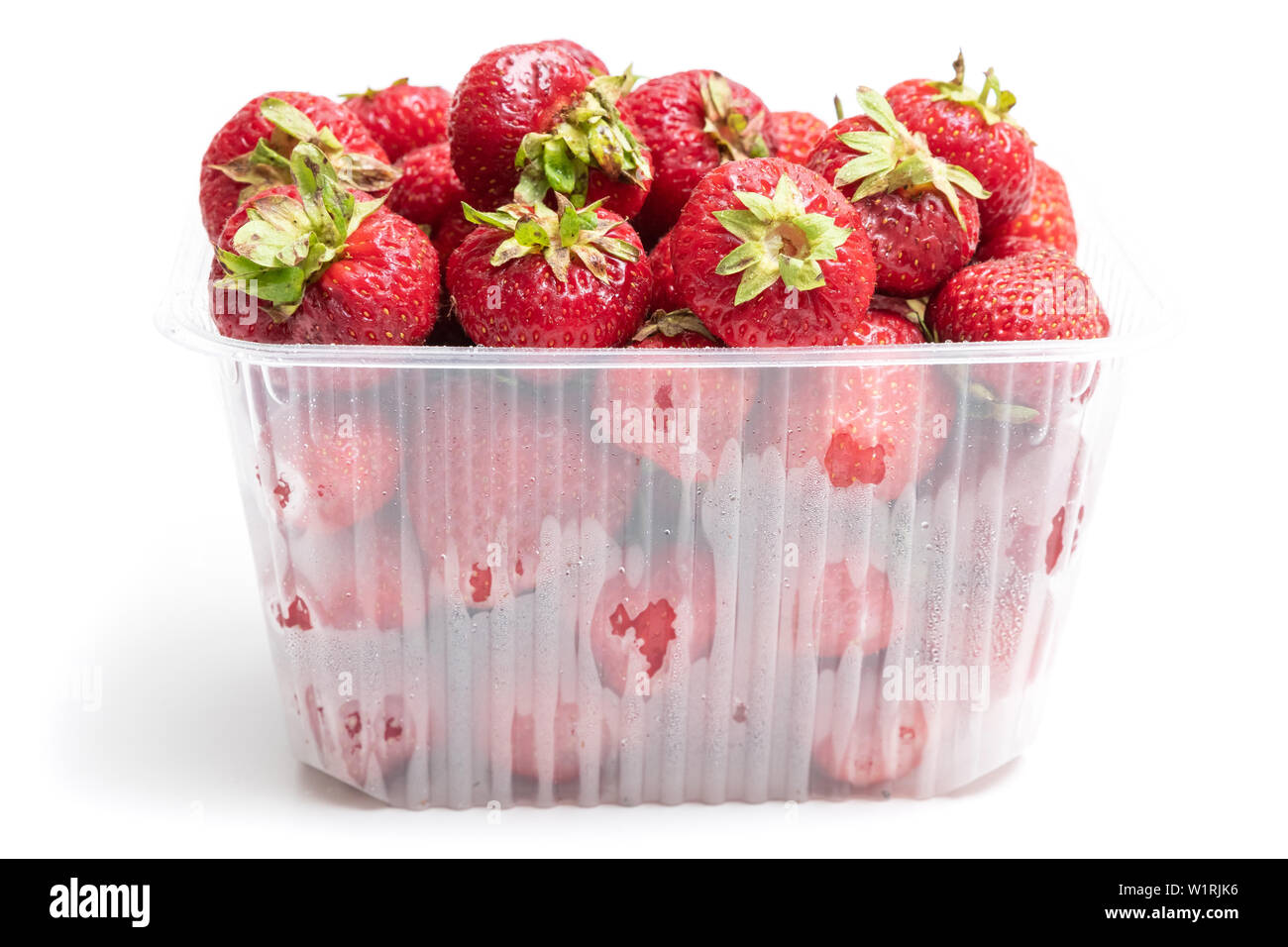 Description: strawberry in plastic transparent container box, isolated on white background Stock Photo