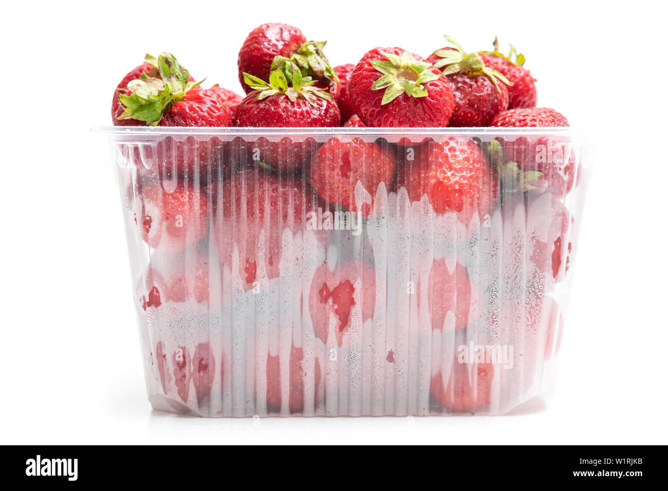 Description: strawberry in plastic transparent container box, isolated on white background Stock Photo