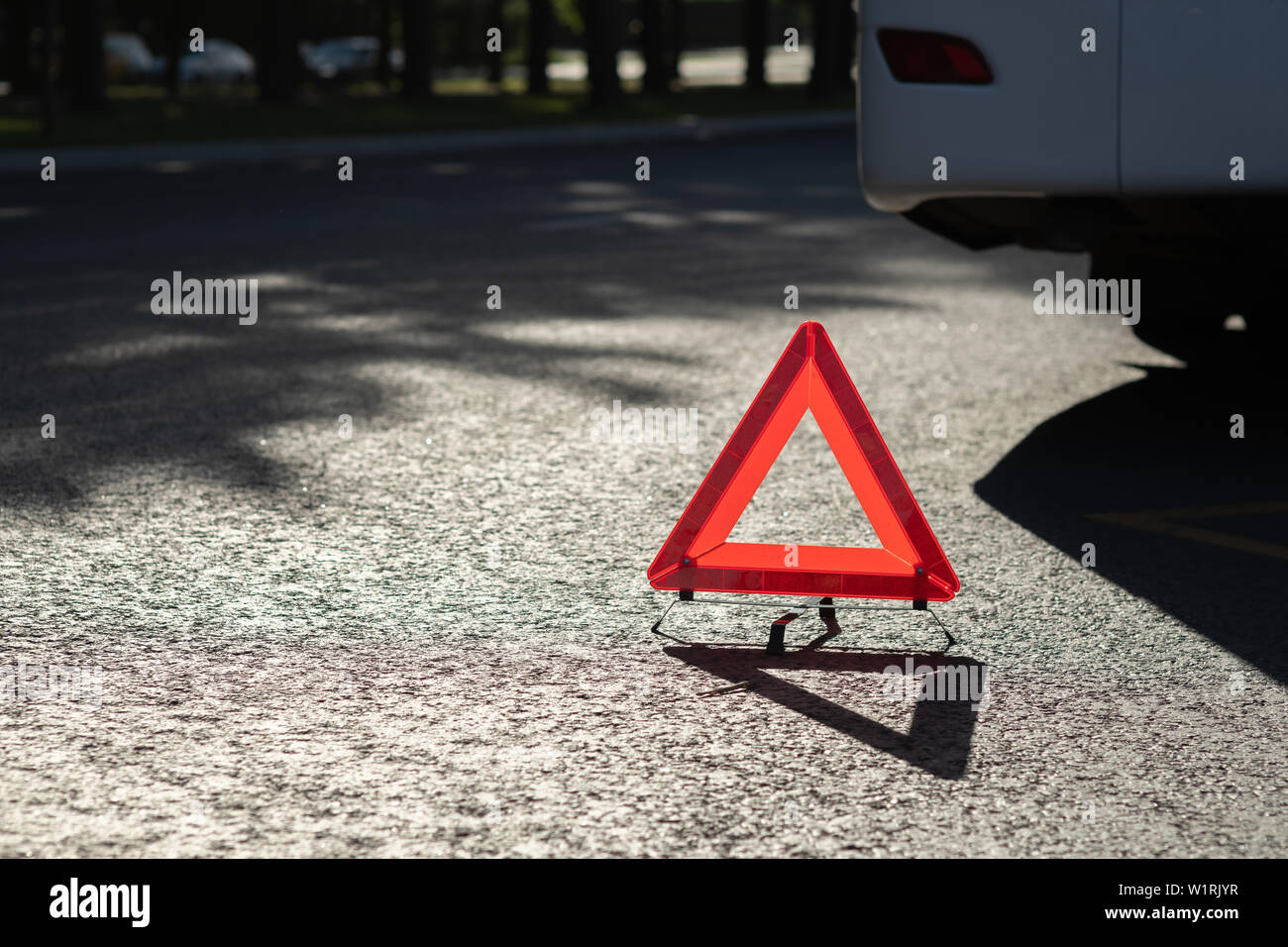 description: Red triangle of a car on the road Stock Photo