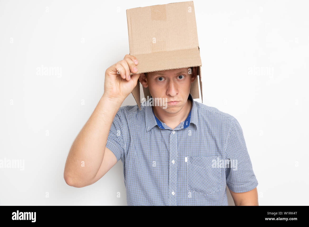 Description man puts a bag on his head Stock Photo Alamy