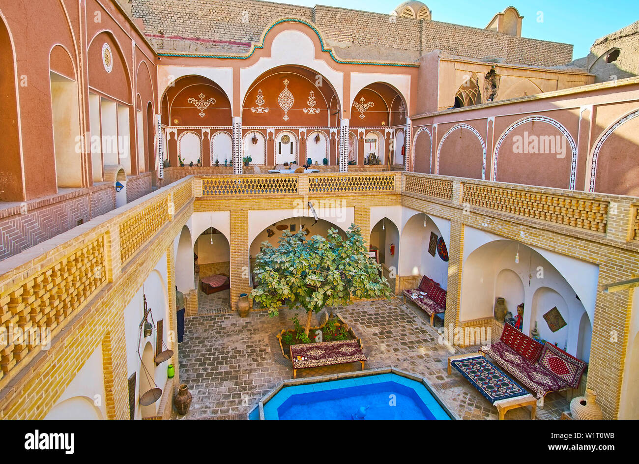 KASHAN, IRAN - OCTOBER 23, 2017: The deep courtyard of historical Iranian house modifies the microclimate, providing cool fresh air, on October 23 in Stock Photo