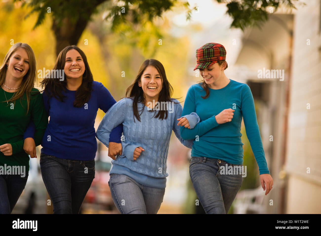 Girls linking arms and walking Stock Photo Alamy