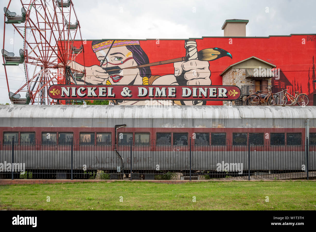 Fort Smith, Arkansas - The Nickel & Dime Diner, below wall art and a Ferris wheel. The painting is 'War Paint' by a British artist known as D*FACE, wh Stock Photo