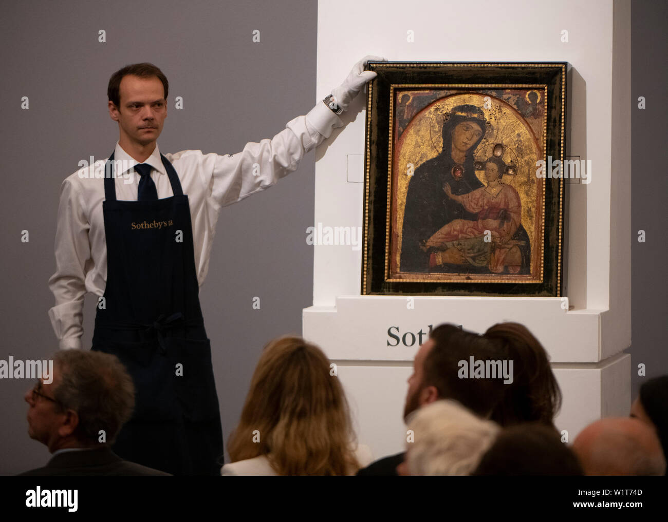 Sotheby’s, London, UK. 3rd July 2019. The summer Old Masters Evening sale offers paintings from the 14th - 19th century by many of the most important painters of Western art. Image: The sale opened with “The Madonna And Child” by Third Master of Anagni which was driven to £735,000 by eight bidders. Dating from the mid-1230s this is the oldest work ever offered in an Old Masters sale at Sotheby’s. Credit: Malcolm Park/Alamy Live News. Stock Photo