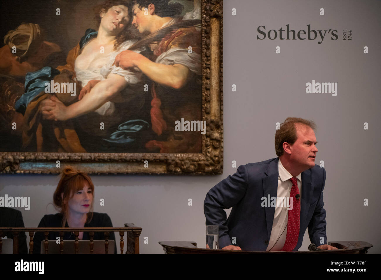 Sotheby’s, London, UK. 3rd July 2019. The summer Old Masters Evening sale offers paintings from the 14th - 19th century by many of the most important painters of Western art. Highlights include a masterpiece by each of Britain’s greatest landscape painters: Turner, Constable and Gainsborough, and extraordinary works from the Baroque including the exceptionally rare Johann Liss (photograph), The Temptation of Saint Mary Magdalene, which sells for £5,665,000. Sale total for the evening was £56,205,950 sterling, the auction taken by Harry Dalmeny (pictured). Credit: Malcolm Park/Alamy Live News. Stock Photo