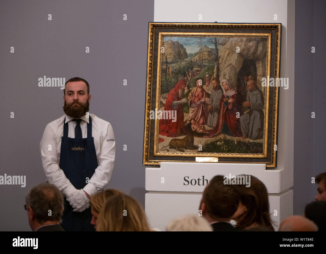 Sotheby’s, London, UK. 3rd July 2019. The summer Old Masters Evening sale offers paintings from the 14th - 19th century by many of the most important painters of Western art. Highlights include a masterpiece by each of Britain’s greatest landscape painters - Turner, Constable and Gainsborough - and extraordinary works from the Baroque by Ribera and the exceptionally rare Johann Liss. Image: Altobello Melone, The Adoration with Saints Francis of Assisi, Catherine of Alexandria, Jerome and Bernardino of Siena, the Shepherds and Magi, sells for £200,000. Credit: Malcolm Park/Alamy Live News. Stock Photo