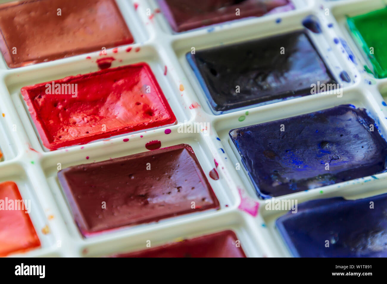 Creative artistic education concept - the box with the set of colorful watercolor paint close up Stock Photo
