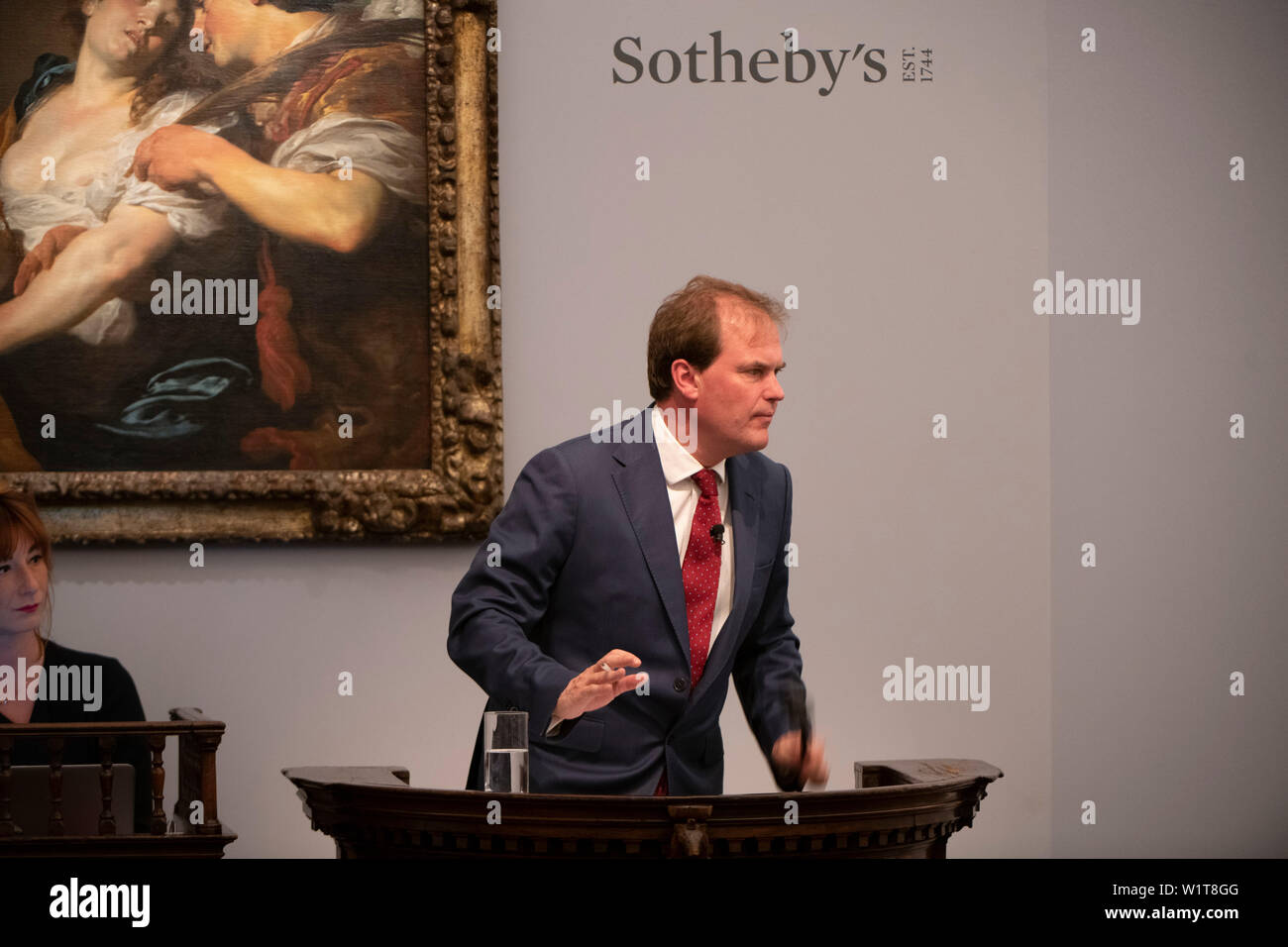 Sotheby’s, London, UK. 3rd July 2019. The summer Old Masters Evening sale offers paintings from the 14th - 19th century by many of the most important painters of Western art. Highlights include a masterpiece by each of Britain’s greatest landscape painters: Turner, Constable and Gainsborough, and extraordinary works from the Baroque including the exceptionally rare Johann Liss (photograph), The Temptation of Saint Mary Magdalene, which sells for £5,665,000. Sale total for the evening was £56,205,950 sterling, the auction taken by Harry Dalmeny (pictured). Credit: Malcolm Park/Alamy Live News. Stock Photo