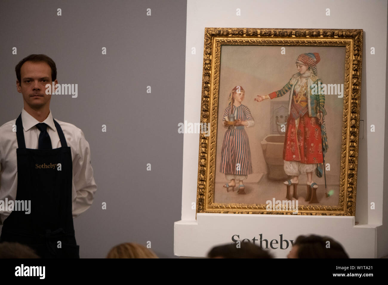 Sotheby’s, London, UK. 3rd July 2019. The summer Old Masters Evening sale offers paintings from the 14th - 19th century by many of the most important painters of Western art. Highlights include a masterpiece by each of Britain’s greatest landscape painters - Turner, Constable and Gainsborough - and extraordinary works from the Baroque by Ribera and the exceptionally rare Johann Liss. Image: Jean-Etienne Liotard, A Woman in Turkish costume in a Hamam instructing a Servant, sells for £2,355,000. Credit: Malcolm Park/Alamy Live News. Stock Photo