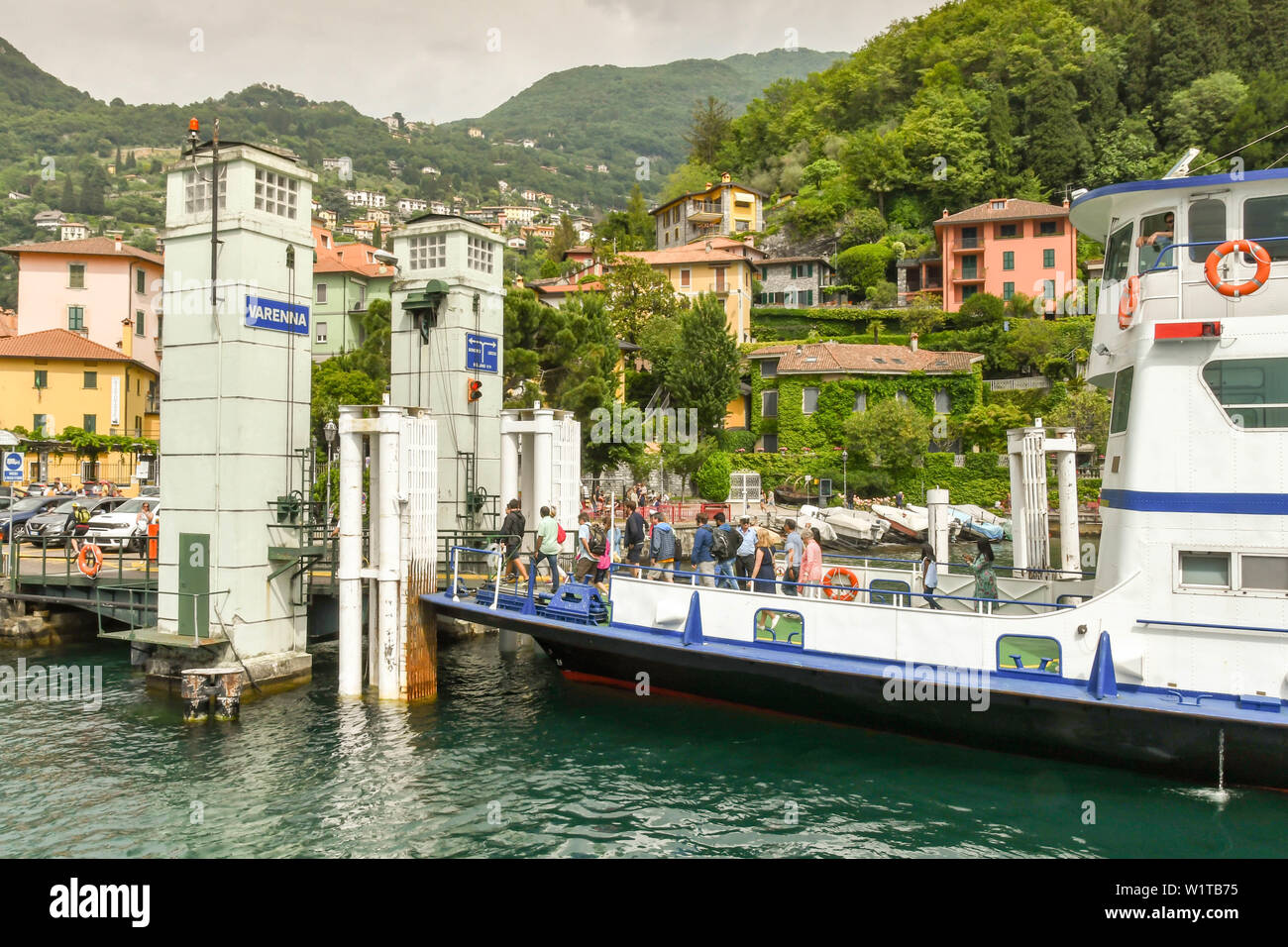 VARENNA, LAKE COMO, ITALY - JUNE 2019: Passengers disembarking a car ferry at the jetty in Varenna on Lake Como. Stock Photo