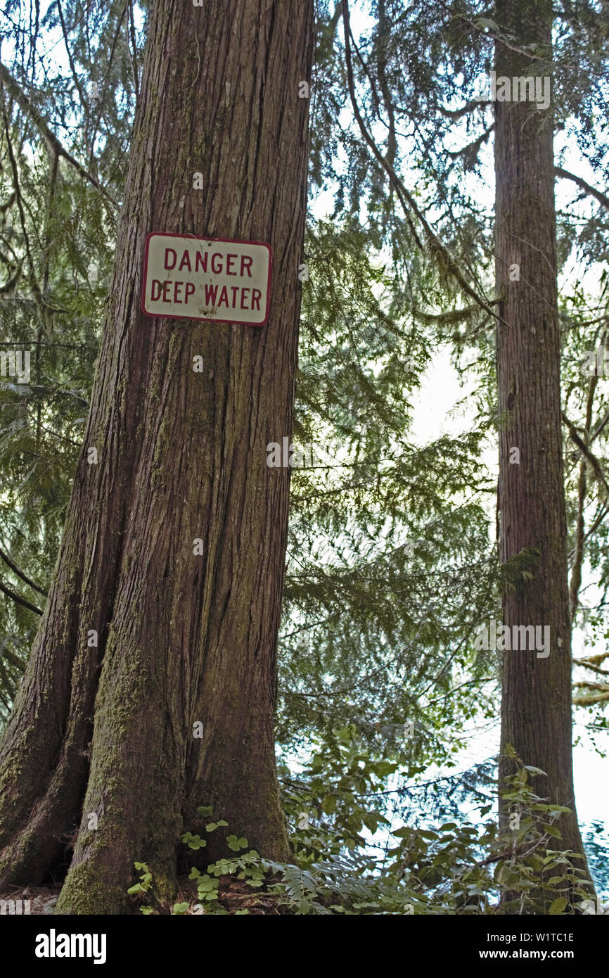 A sign in an Oregon stare park warns visitors of potential danger. Stock Photo