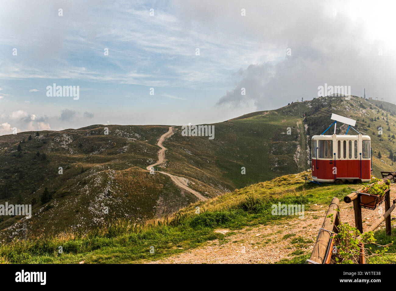 Old cable way lift gondola cab abandoned in peak panorama of Monte Baldo mountain near Malcesine in Italy Stock Photo