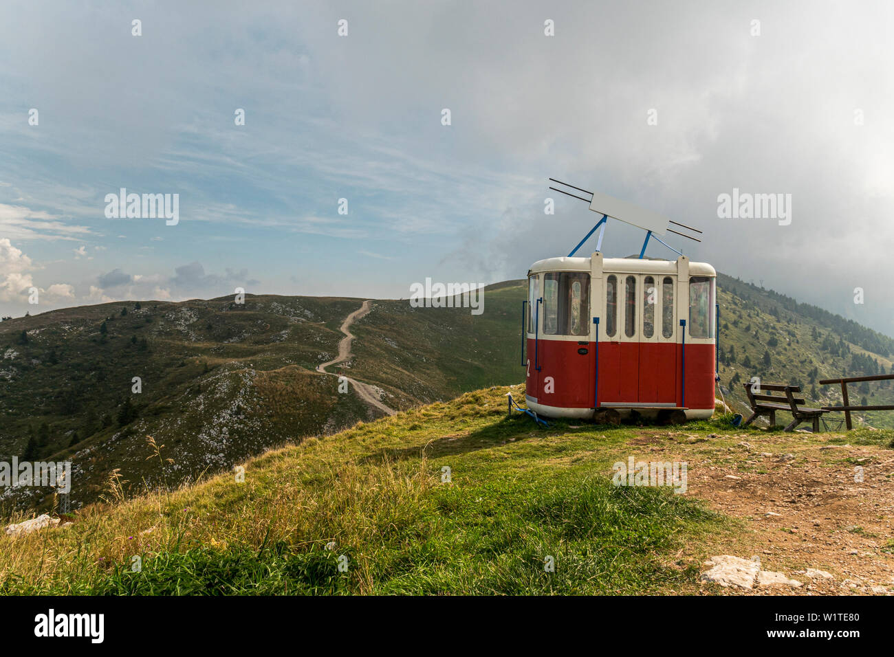 Old cable way lift gondola cab abandoned in peak panorama of Monte Baldo mountain near Malcesine in Italy Stock Photo