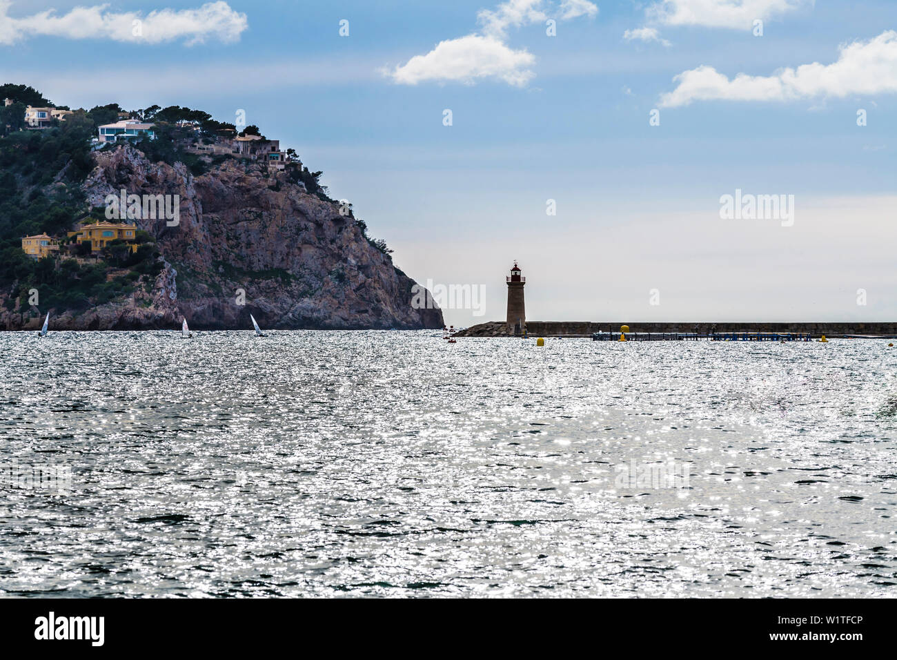 Port exit with lighthouse, Port d'Andratx, Mallorca, Spain Stock Photo
