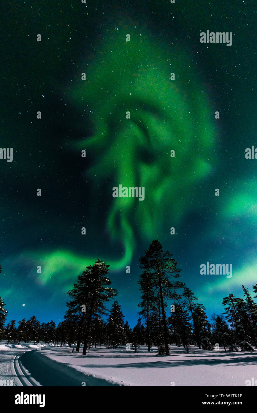 Northern lights above the ski tracks of Luosto, finnish Lapland Stock Photo