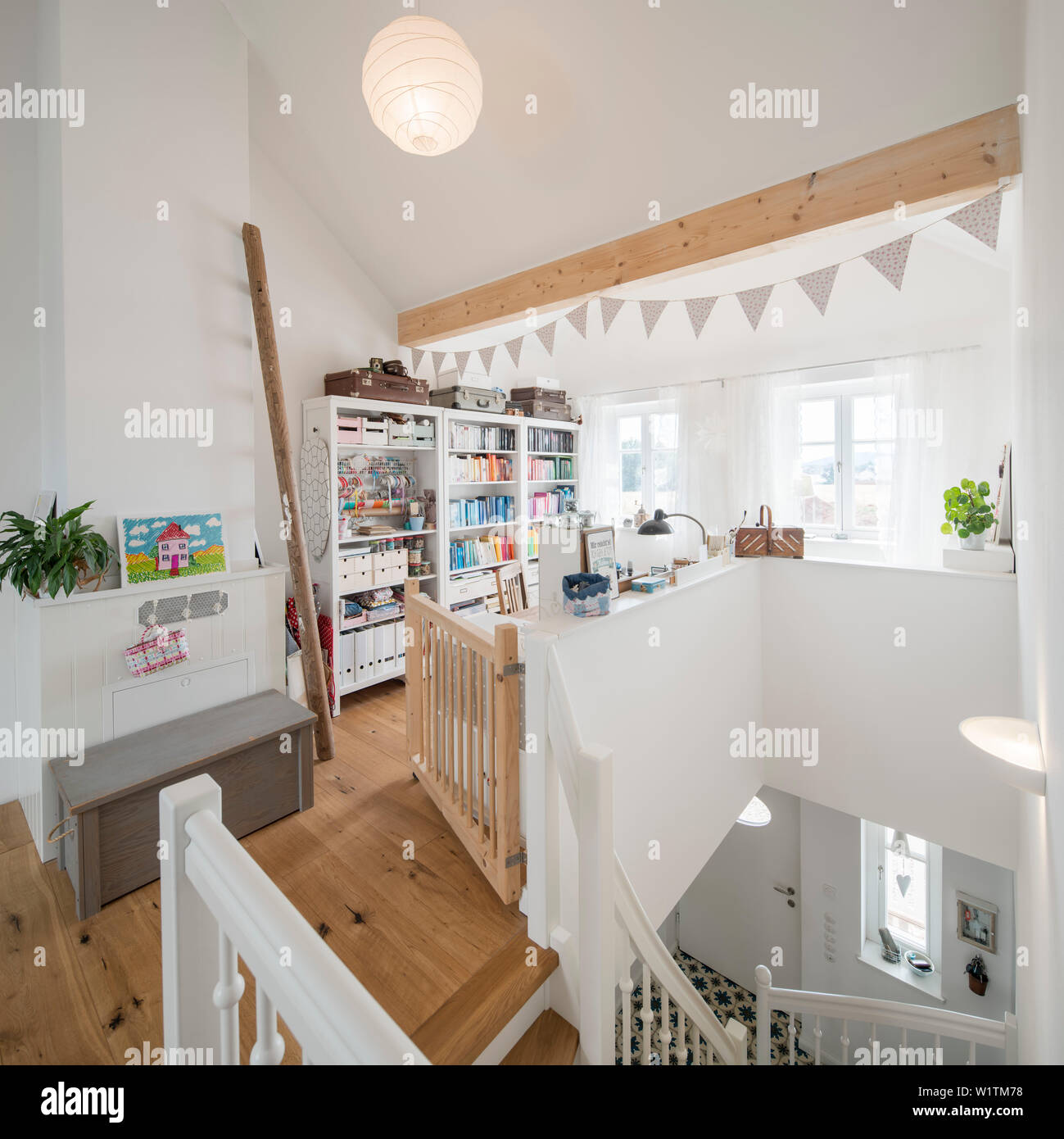 Modern Nordic furnished attic with manual workstation in family house with wooden floor, Korbach, Hesse, Germany, Europe Stock Photo