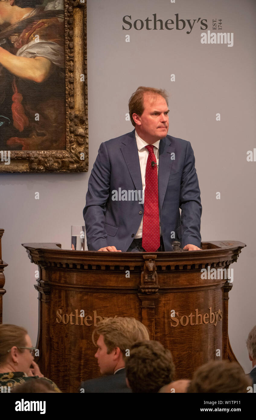 Sotheby’s, London, UK. 3rd July 2019. The summer Old Masters Evening sale offers paintings from the 14th - 19th century by many of the most important painters of Western art. Highlights include a masterpiece by each of Britain’s greatest landscape painters - Turner, Constable and Gainsborough - and extraordinary works from the Baroque by Ribera and the exceptionally rare Johann Liss. Sale total for the evening was £56,205,950 sterling and the auction was taken by Harry Dalmeny, Chairman of Sotheby's UK (pictured). Credit: Malcolm Park/Alamy Live News. Stock Photo