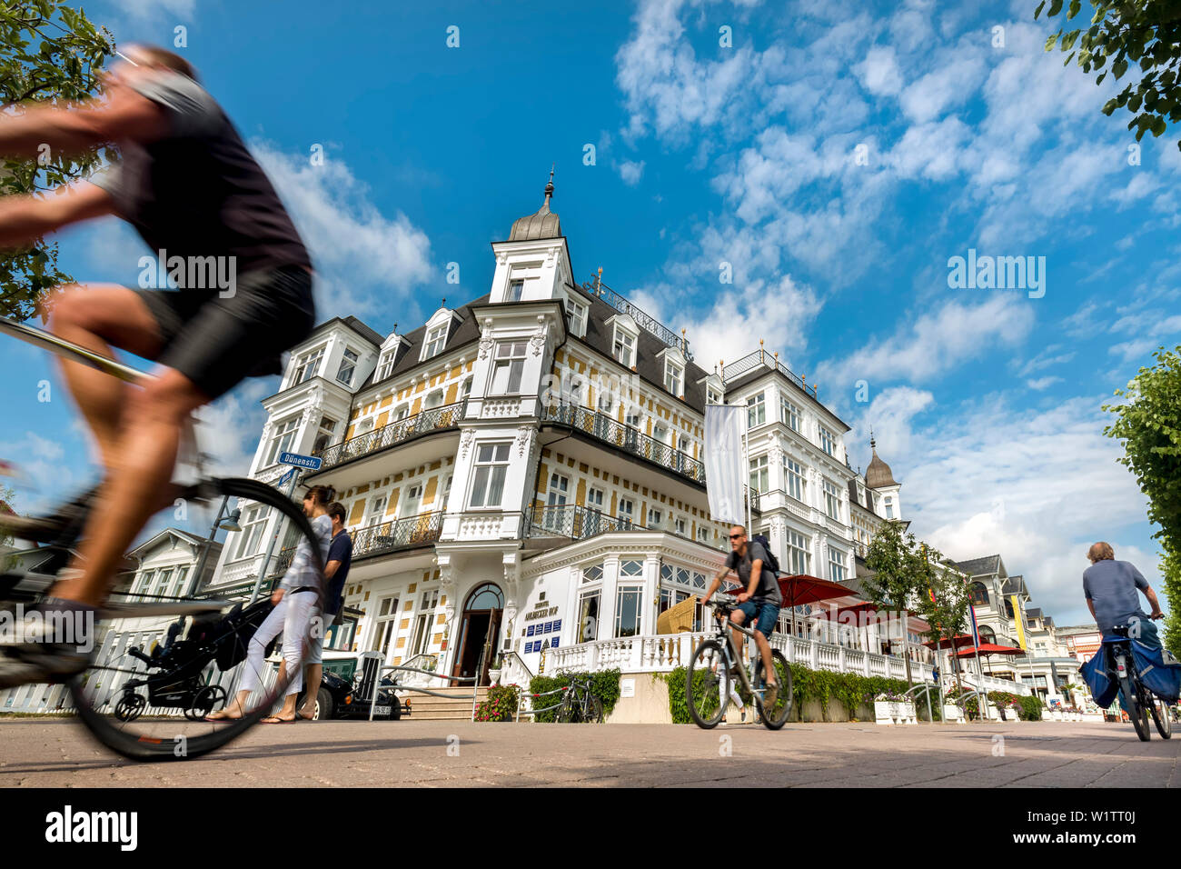 Cyclists in front of Hotel Ahlbecker Hof, Ahlbeck, Usedom island, Mecklenburg-Western Pomerania, Germany Stock Photo
