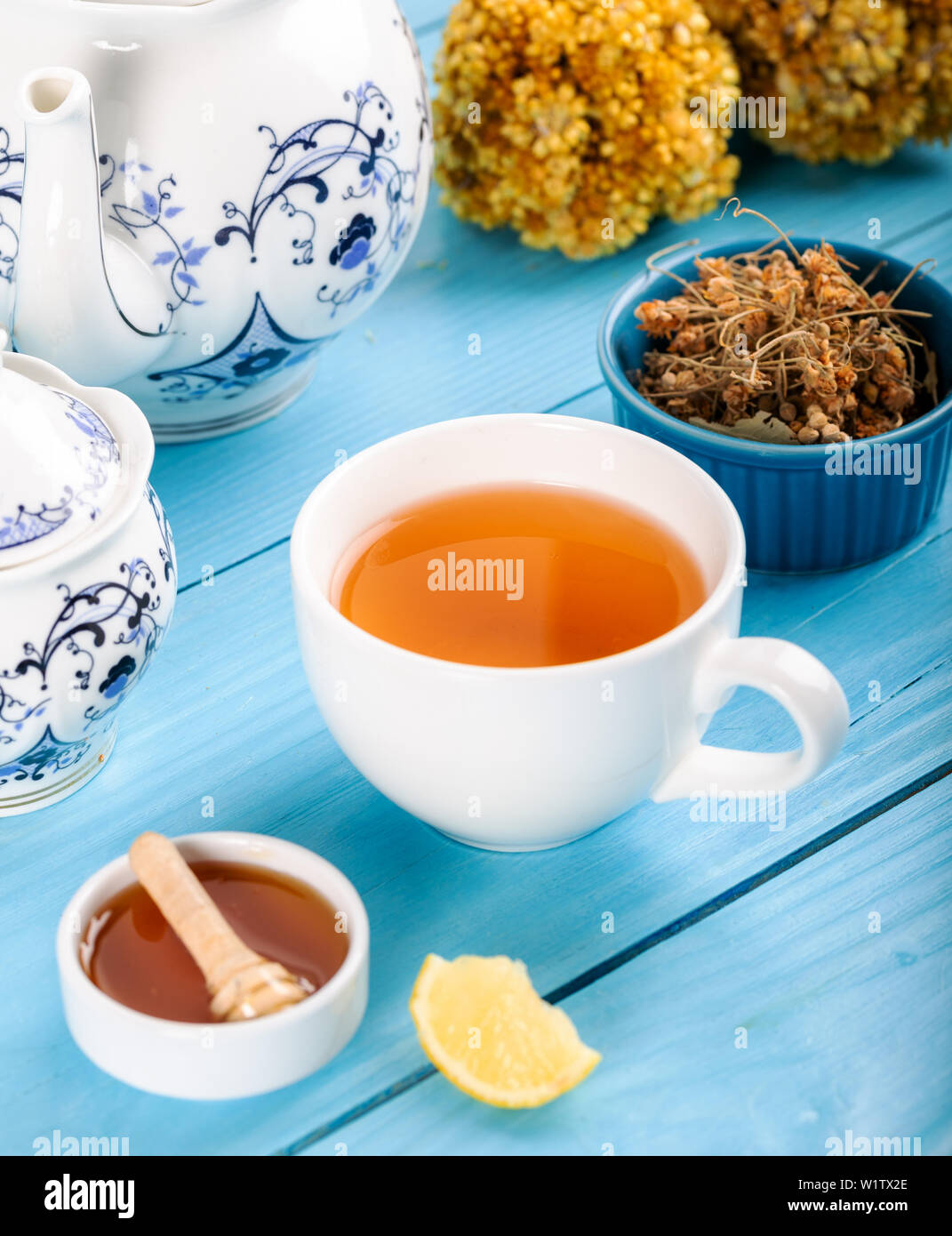 Cup of Linden Tea, Dried Linden Flowers in Cup with honey and lemon on wooden background. Stock Photo