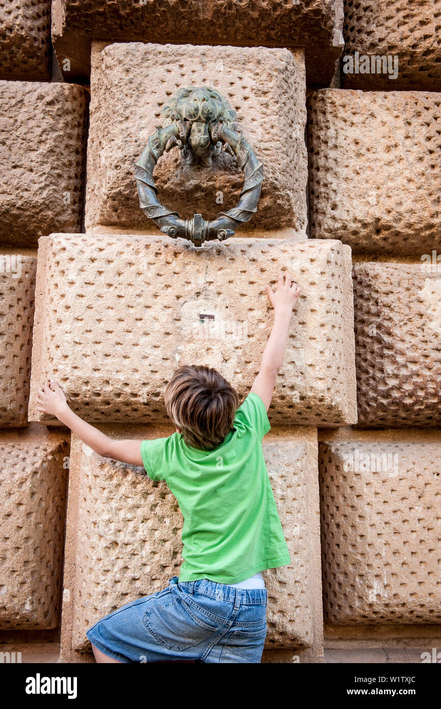 child trying to reach the brass ring, Alhambra, Granada, Andalusia, Spain, Europe Stock Photo
