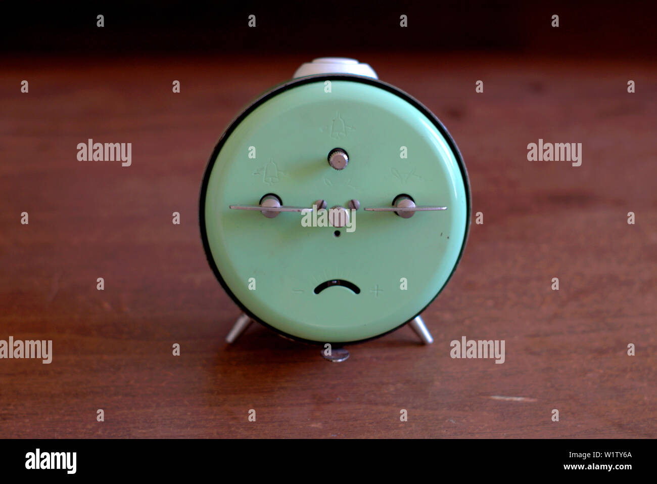 Old mechanical alarm clock on a wooden table. Stock Photo