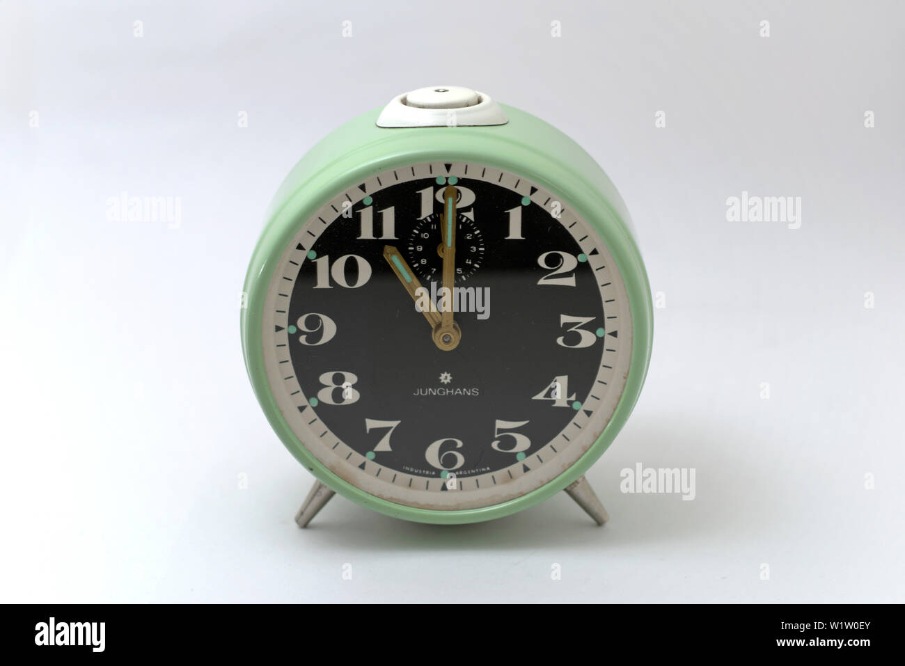An old mechanical alarm clock, showing eleven o'clock Stock Photo Alamy
