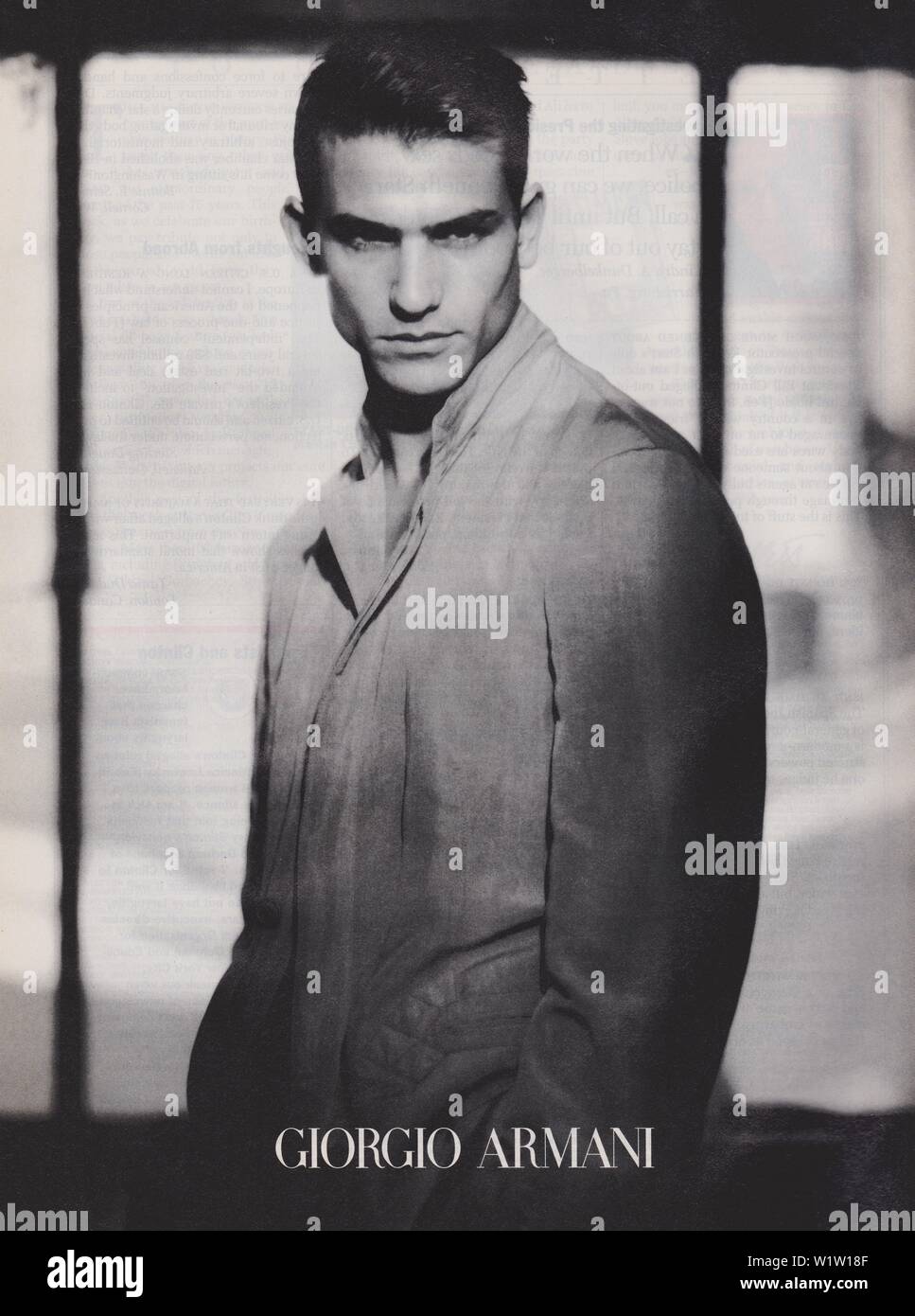 poster advertising Giorgio Armani male model in paper magazine