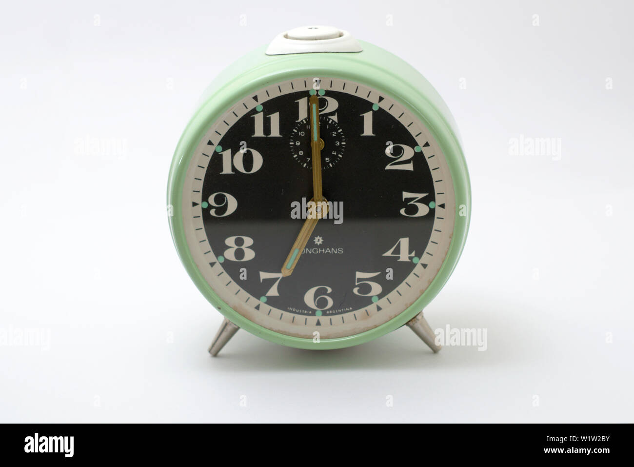 An old mechanical alarm clock, showing seven o'clock Stock Photo Alamy