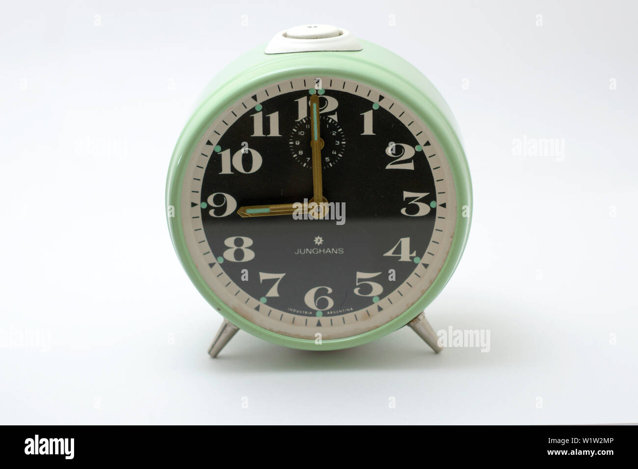An old mechanical alarm clock, showing nine o'clock Stock Photo Alamy