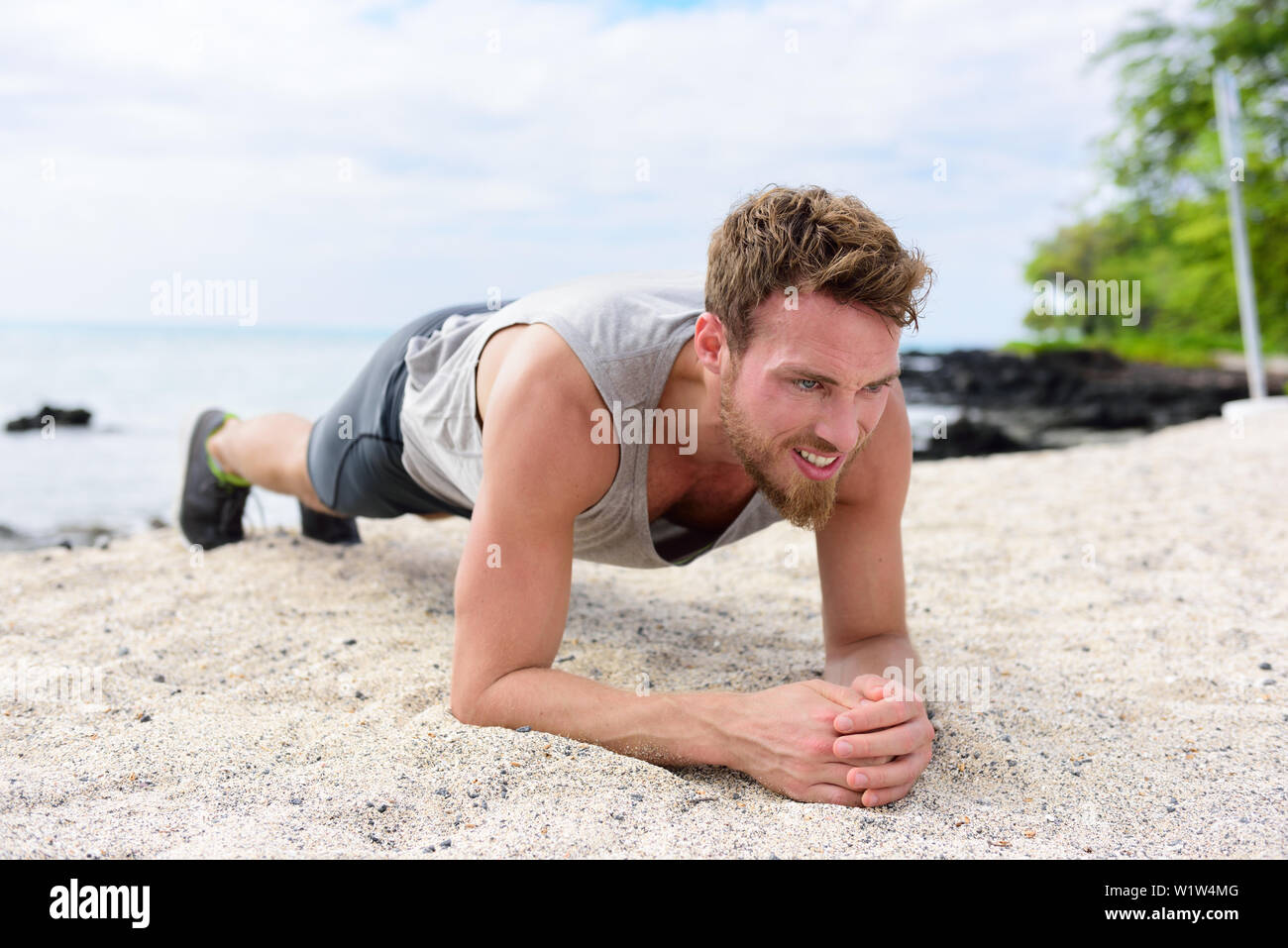 Crossfit training fitness man doing plank core exercise working out his