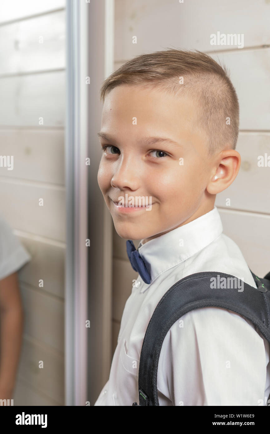 A 10-year-old boy prepares for school after a long summer break. Back to  school. In front of the mirror Stock Photo - Alamy