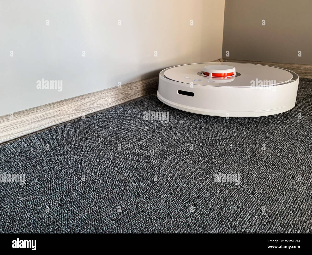 Smart House Vacuum Cleaner Robot Runs On Floor In A Living Room
