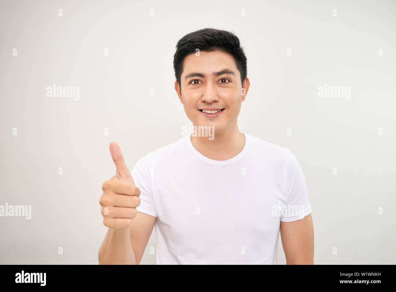 Portrait of happy smiling asian young handsome man with thumb up on ...