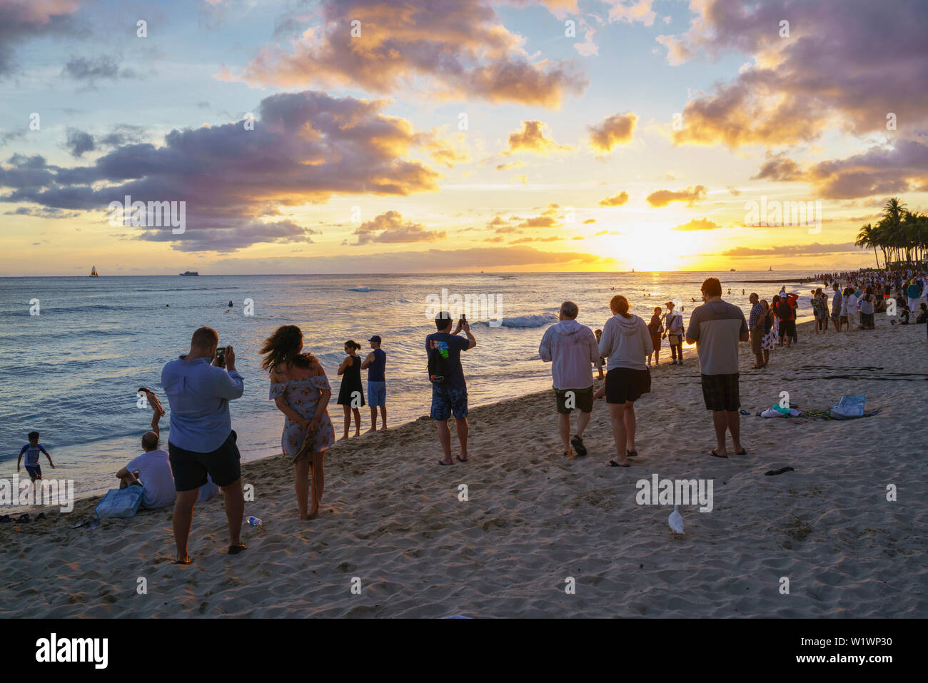 Tourist on Waikiki Line up for sunset photos in Hawaii Stock Photo