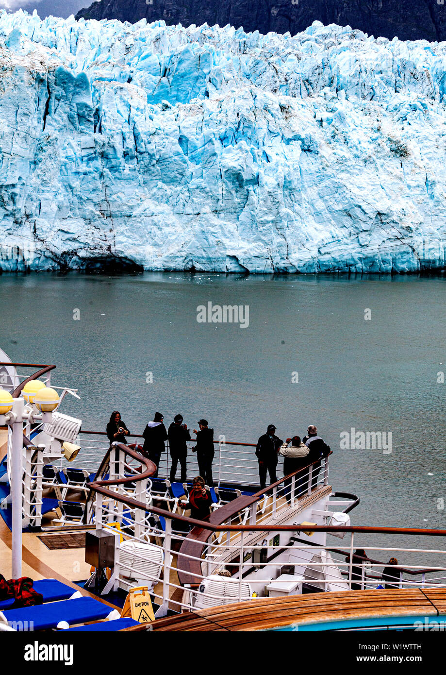 Cruise ship passengers enjoy a close up view of glaciers on Glacier Bay in Alaska from their cruise ship Stock Photo