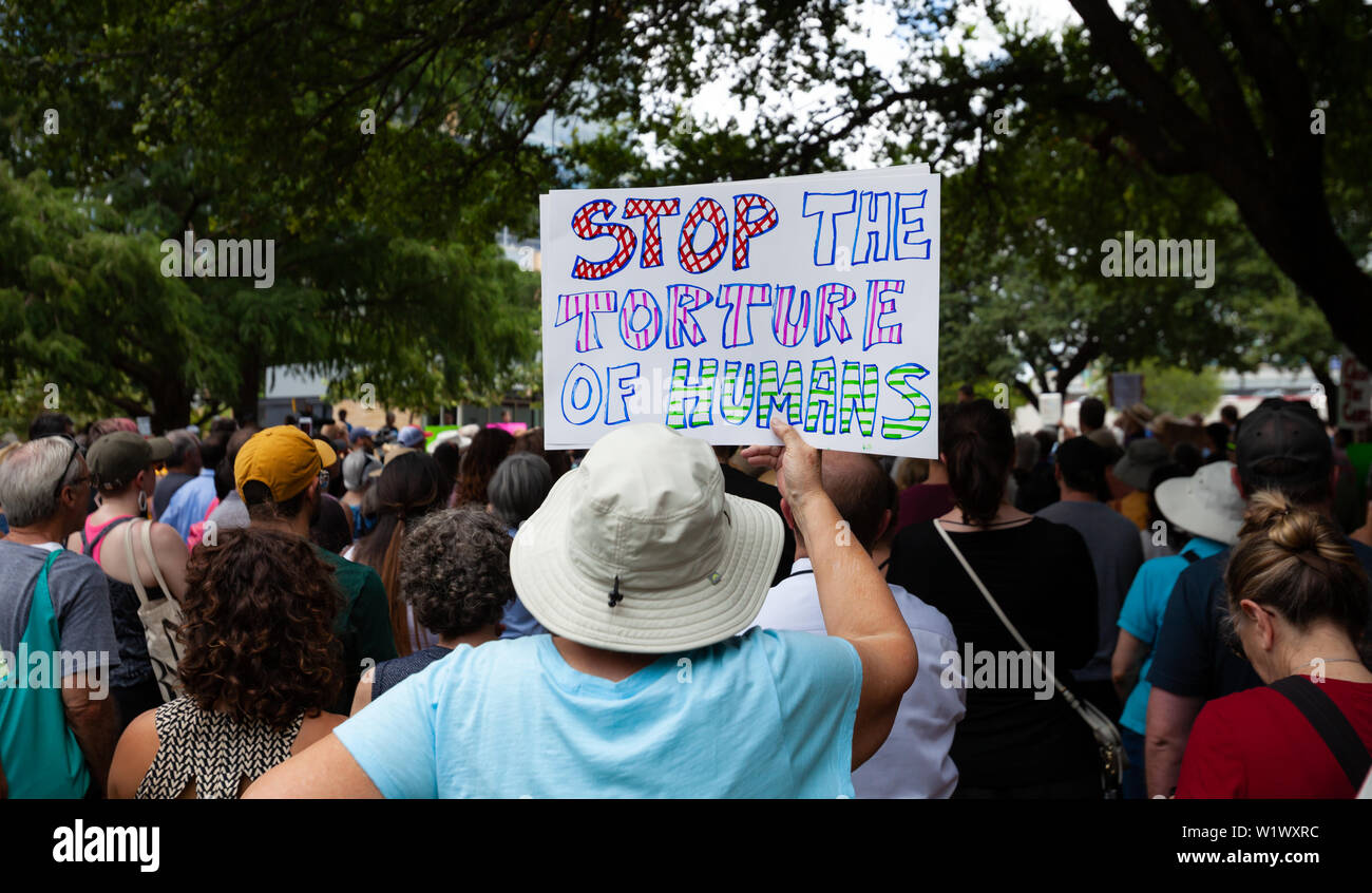 AUSTIN, TEXAS - JULY 2, 2019 - People protesting against President Donald Trump and border camps. Different demands written on pancards. Stock Photo