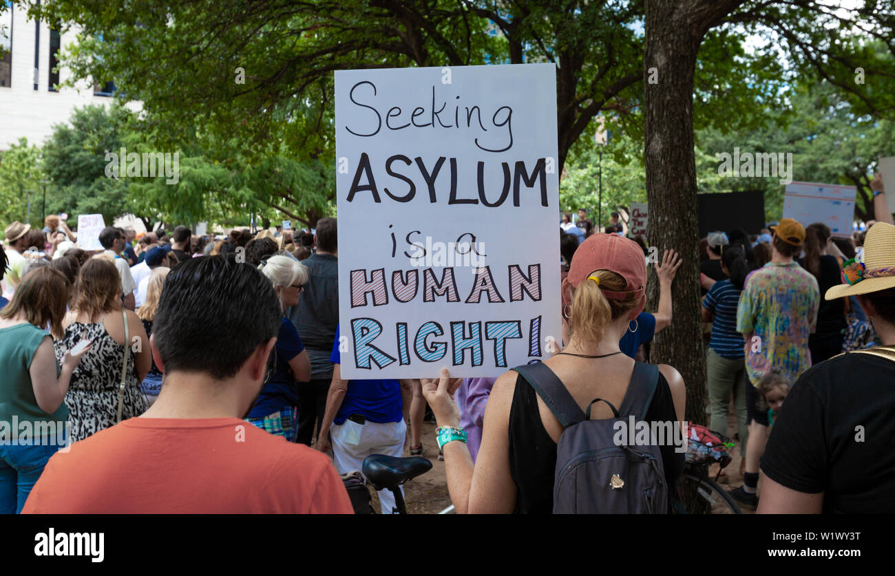 AUSTIN, TEXAS - JULY 2, 2019 - People protesting against President Donald Trump and border camps. Different demands written on pancards. Stock Photo